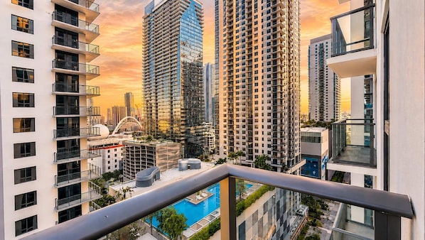 A high-rise building with multiple balconies, a swimming pool, and a view of other tall buildings. - Stylish 1BR in the Heart of Miami (Miami)