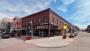 A brick building with a storefront labeled 'BIG RED TREATS' and a star-shaped sign.
