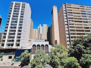 Un edificio moderno de gran altura, con varios pisos, ventanas amplias y una entrada destacada.