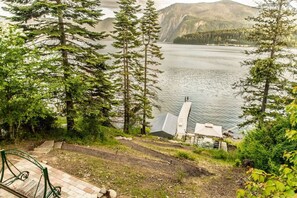 A scenic overlook with a view of a lake and mountains, a wooden staircase, and a small shelter with a roof. - Stylish Waterfront Retreat in Bayview-Boat Dock (Bayview)