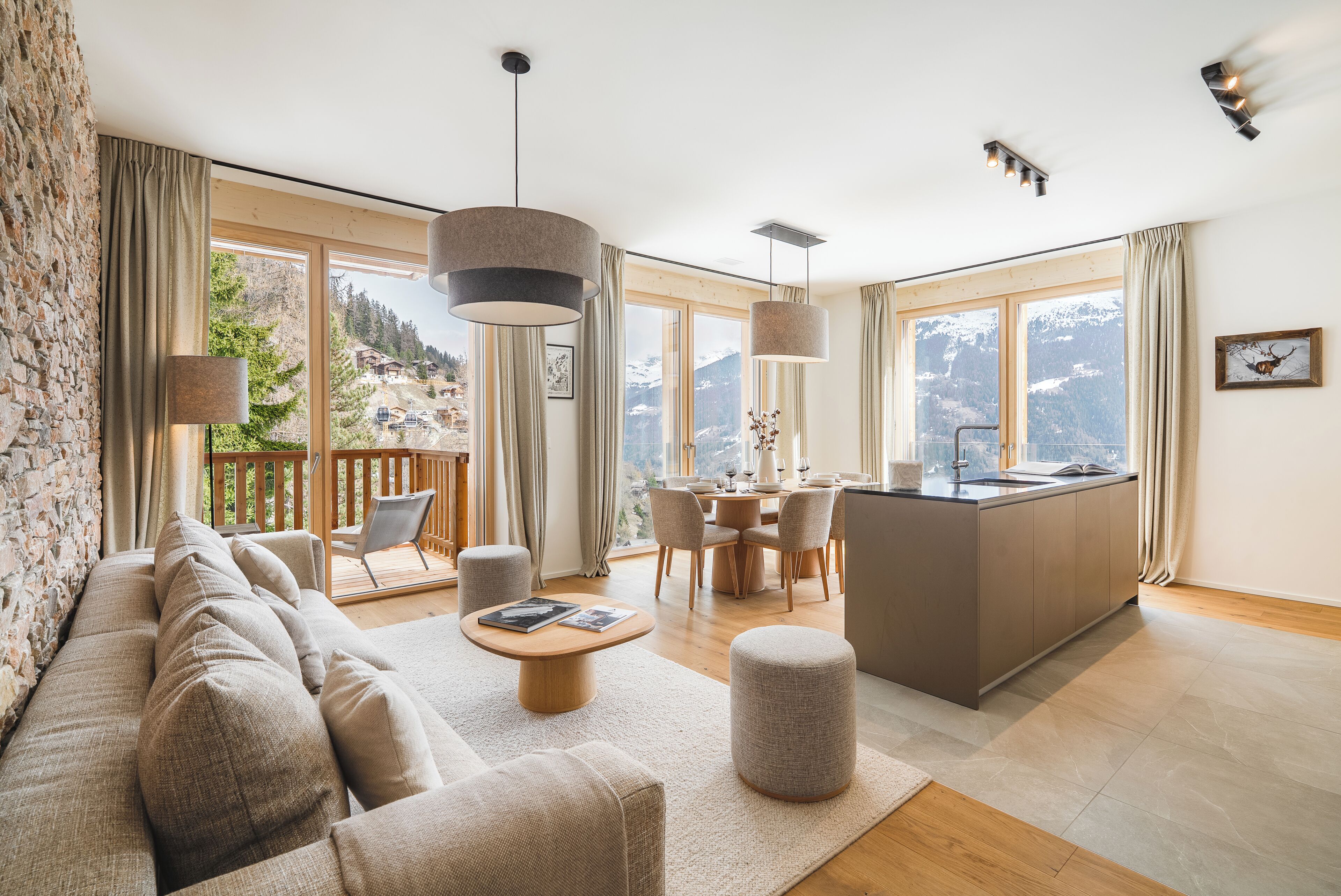 A modern living room with a sofa, a dining area, and a kitchen.