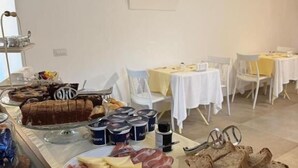 A breakfast buffet with various food items, including meats, cheeses, and bread. - Villa Aurelia (Locorotondo)