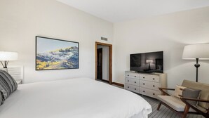 A hotel room with a large bed, a television, a dresser, a chair, and a painting on the wall. - 3BR SKI-IN/OUT JAN 2-9, FREE LIFT TICKETS -FORMALLY TIMBERS/RITZ BACHELOR GULCH (Avon)