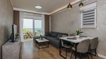 Classic Apartment, 1 Bedroom, Sea View | Living area | Flat-screen TV
