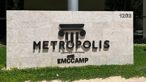 En byggnad med en skylt som visar texten ”METROPOLIS EMCCAMP” och siffran ”1203” på en fasad av sten.