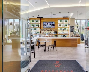 Eine moderne Bar mit Fernseher, Holztresen und Sitzgelegenheiten.