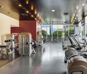 A gym with cardio machines, weight equipment, and large windows offering a view of the outdoors. - New! Chic Studio with Marina & Intracoastal View (Hallandale Beach)