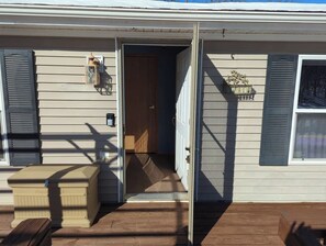 A house with a wooden deck, a sliding door, and a mailbox. - Accessible | Family Friendly | 5 BR | Ripple Lake (Aitken)