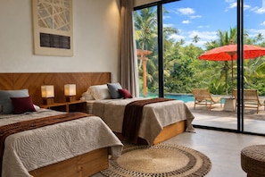 A hotel room with two beds, a large window with a view of palm trees and a pool, and a red umbrella. - Oran Villa Bali (Tampaksiring)