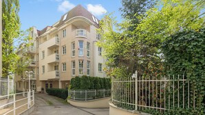 A multi-story residential building with balconies, a gated entrance, and a paved driveway. - Valor by Grand Apartments (Sopot)