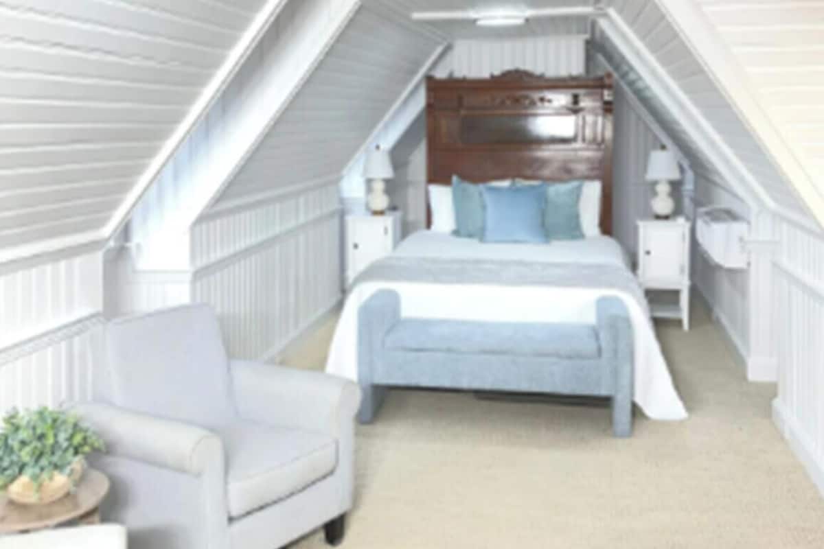 A bedroom with a bed, nightstands, a chair, and a small table with a plant.