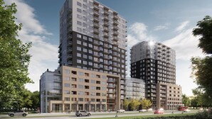 Un moderno edificio de gran altura con varios pisos, ventanas amplias y una combinación de espacios residenciales y comerciales.