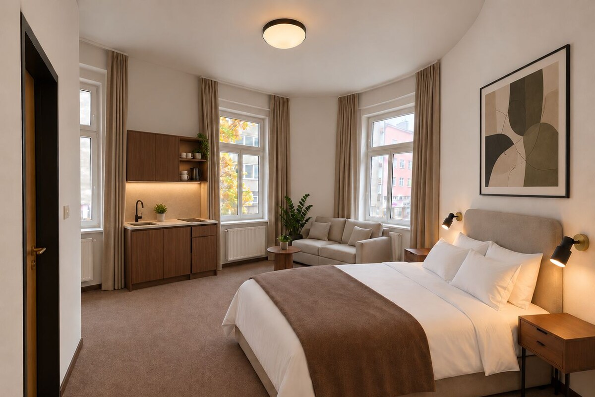 A modern hotel room with a bed, bedside table, and a view of the city.
