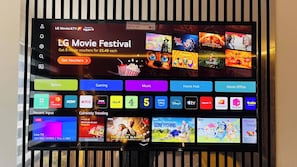 A TV screen displaying a movie festival advertisement and various streaming service icons.