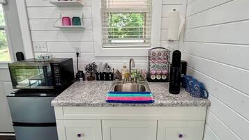 Fridge, microwave, coffee/tea maker, cookware/dishes/utensils