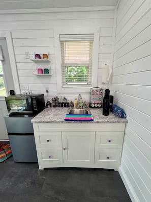 Fridge, microwave, coffee/tea maker, cookware/dishes/utensils