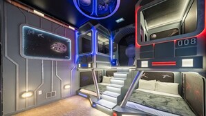 A room with a bed, a desk, and a window. - Immersive Rooms • Gaming Lounge • Summerville (Kissimmee)