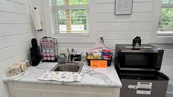 Fridge, microwave, coffee/tea maker, cookware/dishes/utensils