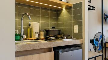 A modern kitchen with a built-in dishwasher, a microwave, a blender, and a stove.