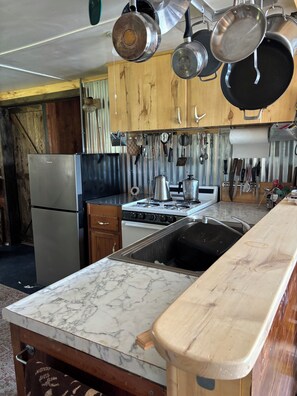 Fridge, microwave, stovetop, cookware/dishes/utensils - 2-bedroom off grid remote cabin near Bigfork perfect for a relaxing getaway. (Bigfork)