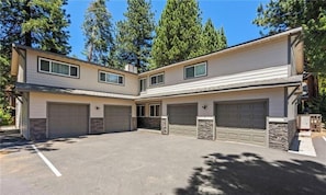 A two-story house with a garage, a driveway, and a clear sky.