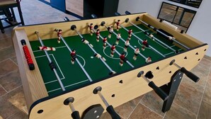 A foosball table with a green playing surface and multiple players. - Large house for 7 people on the outskirts of Brocéliande (Campénéac)