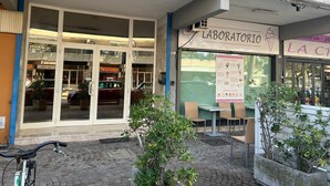 Een etalage met een bord waarop 'LABORATORIO' staat en een menukaart.