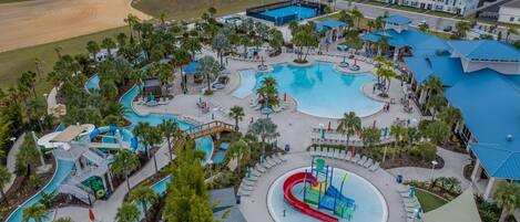 A resort with multiple swimming pools, a water park, and a variety of outdoor seating areas.