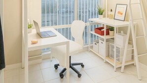 A modern bedroom with a bunk bed, a desk with a laptop, a chair, a ladder, and a window with a city view. - Middle of DOWNTOWN VANCOUVER INDEPENDENT APARTMENT SLEEPS 4 (Vancouver)