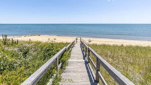 A wooden boardwalk leading to a beach with clear skies. - Popponesset-Exclusive Oceanfront Rental, 3 bedroom, 3.5 baths, sleeps 6 (Mashpee)