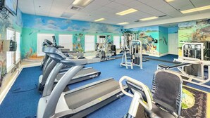 A gym with treadmills, weight machines, and a mural on the walls. - Family 808 Cozy Poolside Retreat  2BR 2BA (Davenport)