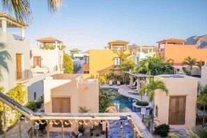 A resort with multiple buildings, a swimming pool, and outdoor seating areas. - AV78 | Mountain Views | Community Pool | Rooftop Tower! (Loreto)