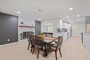 A modern kitchen with white cabinets, a built-in oven, and a stainless steel refrigerator. - Sleeps Ten, Pet friendly, White sand beaches (Pensacola)