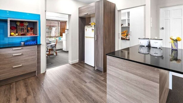 A modern kitchen with wooden cabinets, a black countertop, and a built-in refrigerator. - Cozy 4 bedrooms House BNB at Whangarei Town center. Next to supermarket/ schools (Whangārei)