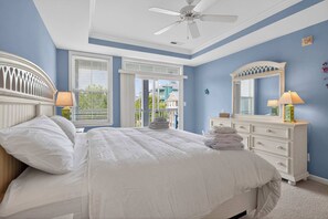 A bedroom with a bed, a dresser, a ceiling fan, and a window with blinds. - 6 Sunset Island Drive 3F (Ocean City)