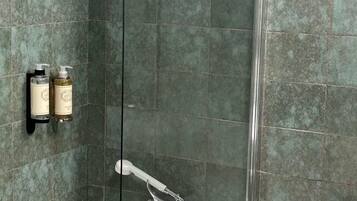 Un baño con bañera, ducha y secamanos.