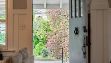 A room with a view of a garden through a door.