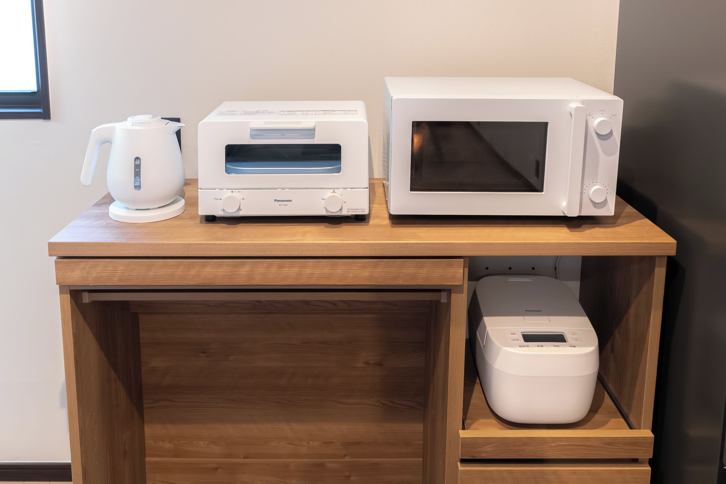 A kitchen counter with a microwave, toaster, and coffee maker.