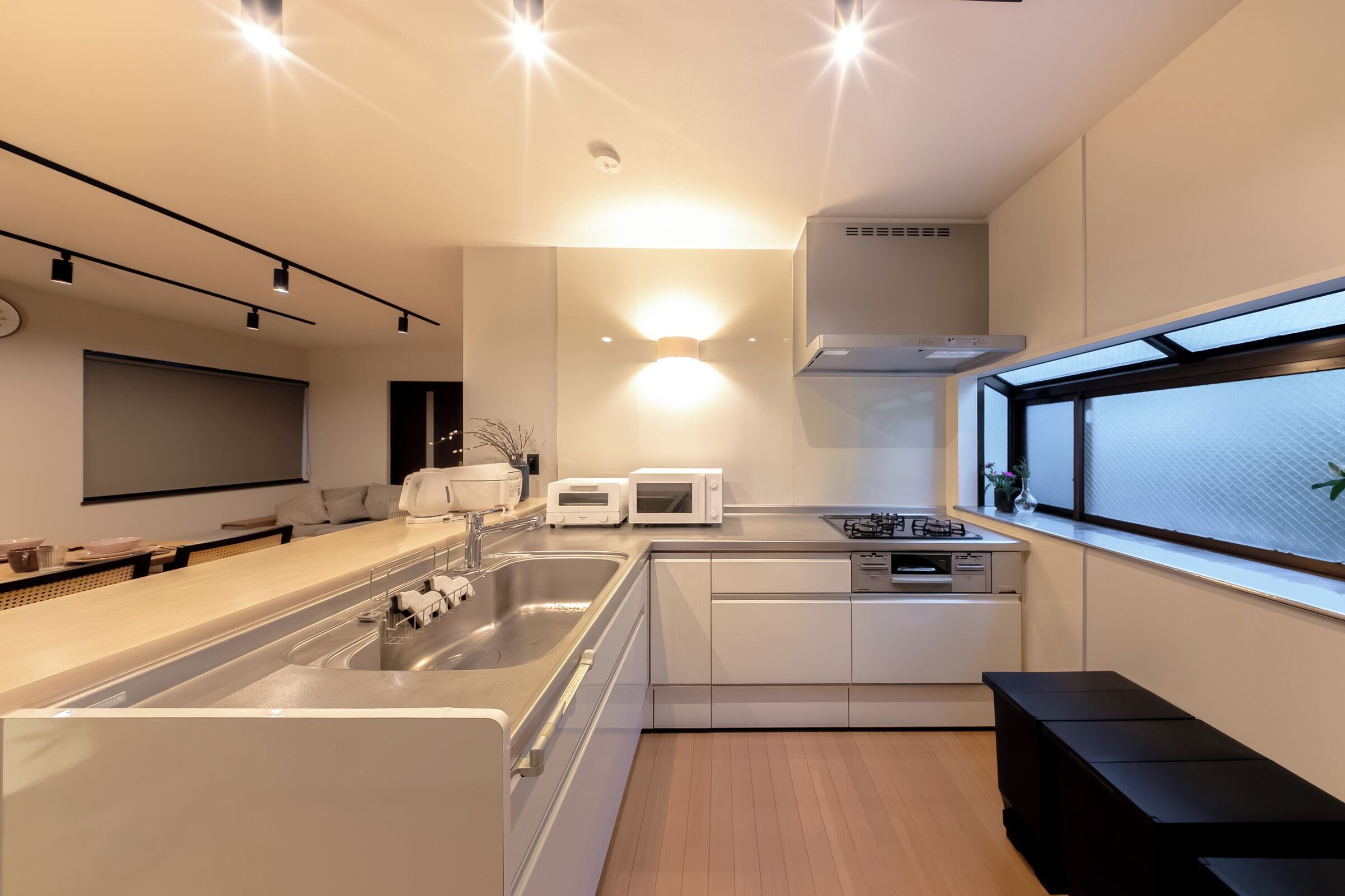 A modern kitchen with a built-in oven, microwave, and sink.