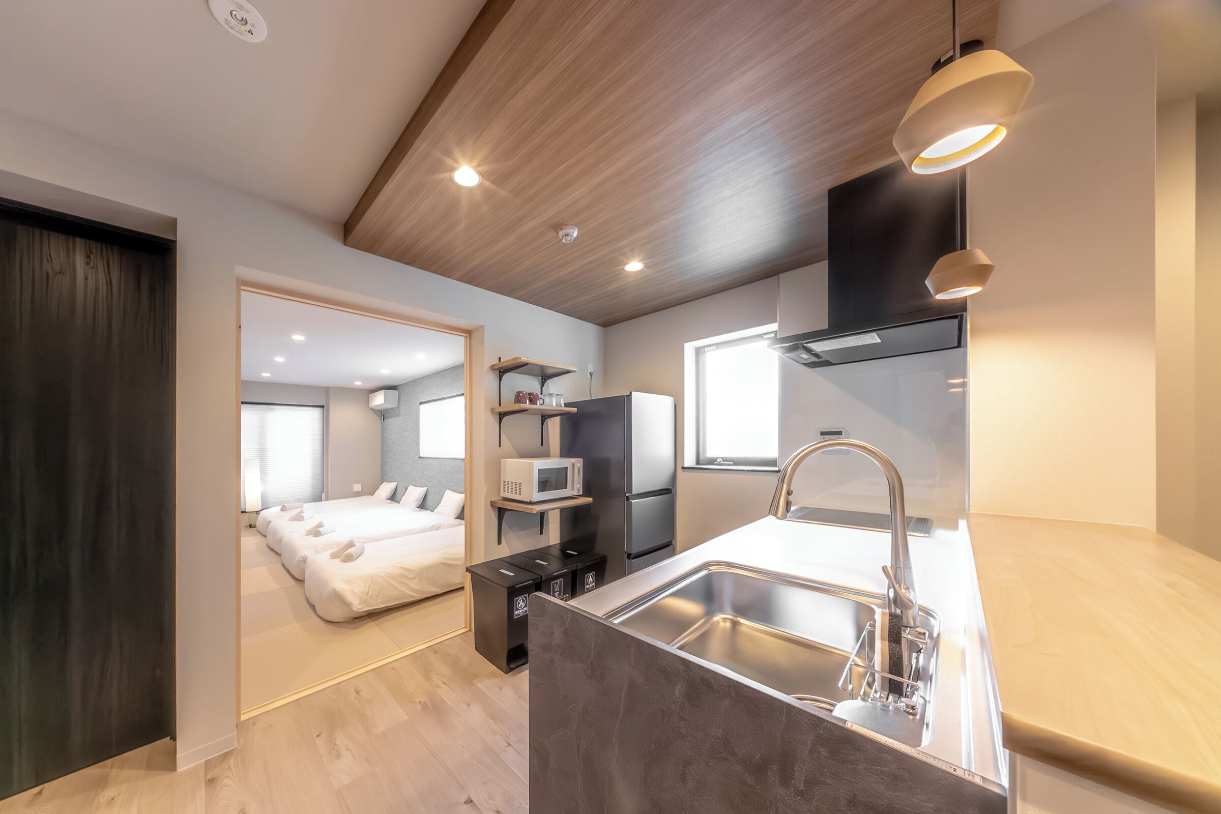 A modern kitchen with a built-in sink, a microwave, and a refrigerator.
