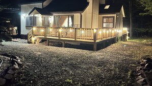 A house with a covered porch, a staircase, and a star on the roof. - Spacious cozy, comfy home in The Poconos, private community of The Hideout (Hamlin)