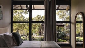 A bedroom with a large window, a bed, and curtains. - Your Noosa Hinterland Hideaway (Doonan)