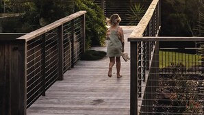 A wooden bridge with metal railings, surrounded by greenery. - Your Noosa Hinterland Hideaway (Doonan)
