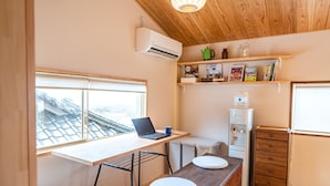 A compact kitchen with a wooden countertop, a laptop, a kettle, and a refrigerator. - entohouse BAR&GUESTHOUSE (Seiyo)