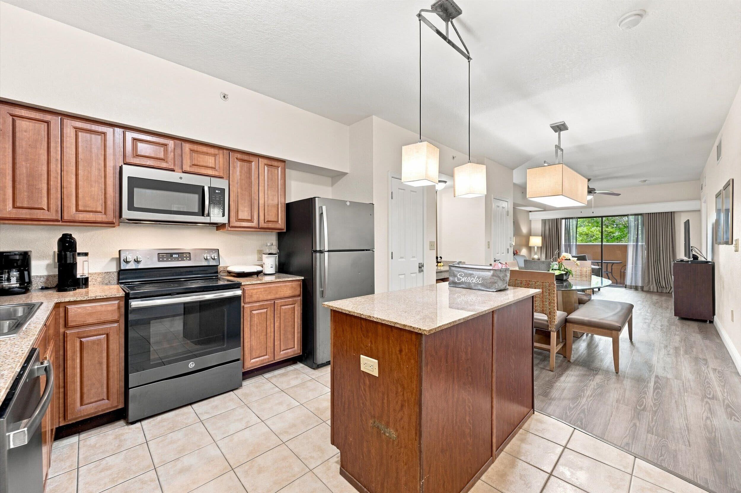 Step into your spacious open-plan retreat, where a fully equipped kitchen with modern appliances flows seamlessly into comfortable living and dining areas—perfect for relaxing after a day of adventure.