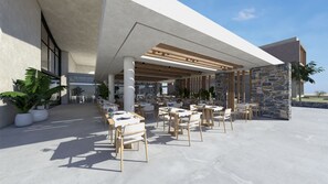 An outdoor dining area with tables and chairs, a pergola, and stone walls. - Unique Blue Resort (Hersonissos)