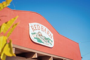 A Red Barn sign with a vintage illustration and the establishment year 1921.
