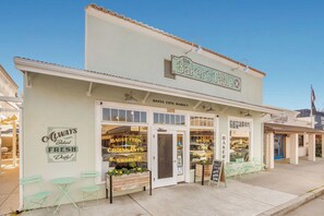 A bakery named 'The Baker's Table' with a sign stating 'Santa Cota Market' and 'Always Baked Fresh Daily!'