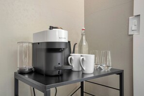 A coffee maker, a glass container, and two white mugs on a table. - Demetria by Polo House and Bungalows (Santa Ynez)