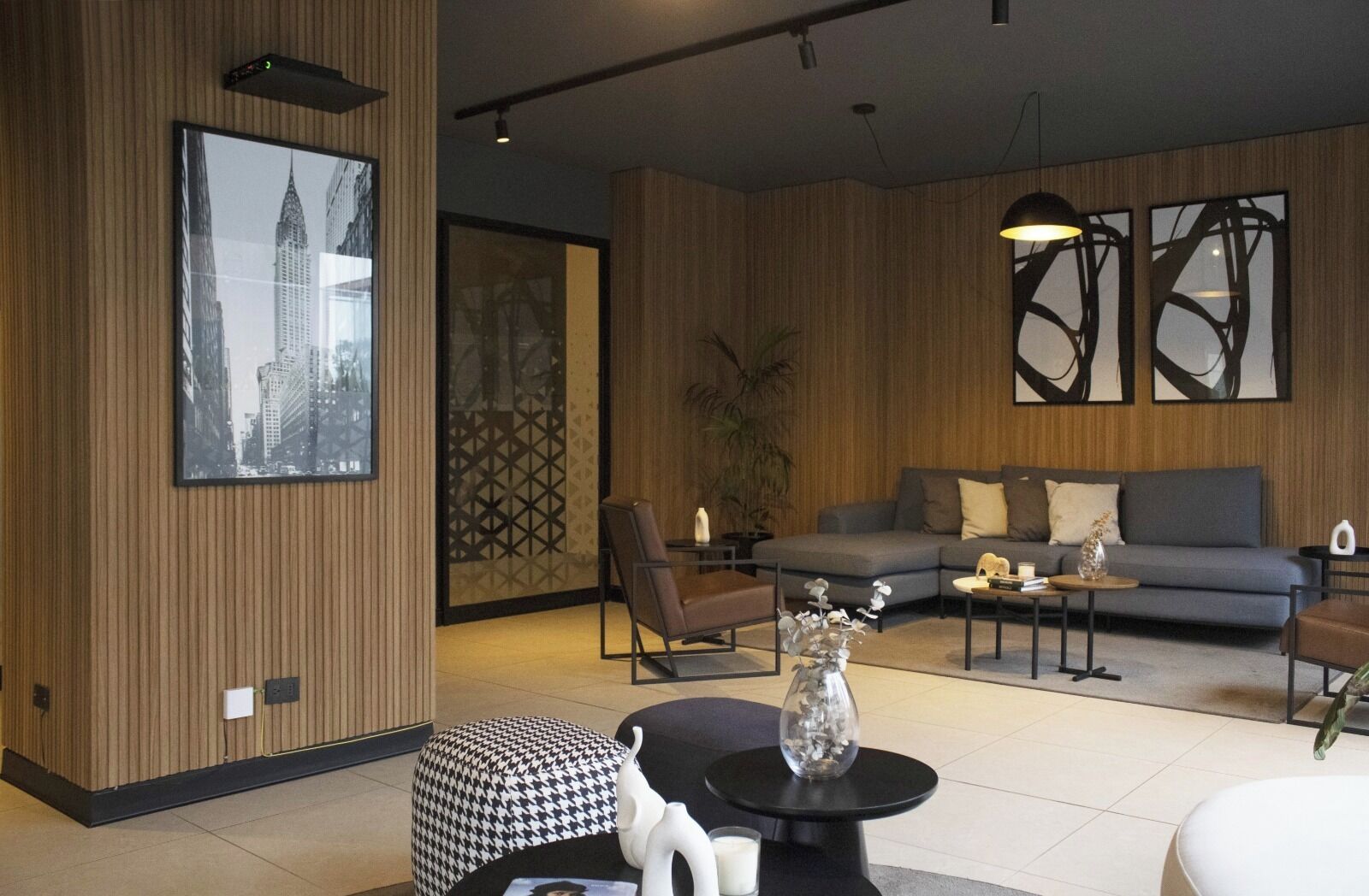 A modern living room with a sofa, coffee table, and decorative items.
